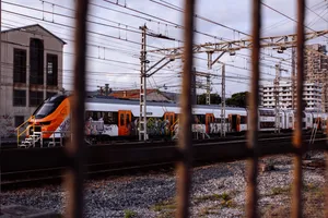The opposite end of the Renfe Class 452. These new high-capacity commuter trains have two low-floor single-deck cars on each end, and two double-decker cars in the middle. The train looks quite sleek, with an orange-on-white Rodalies livery and the Rodalies logo on its sides. It's already been vandalized with several graffities. The train has been numbered 1001.